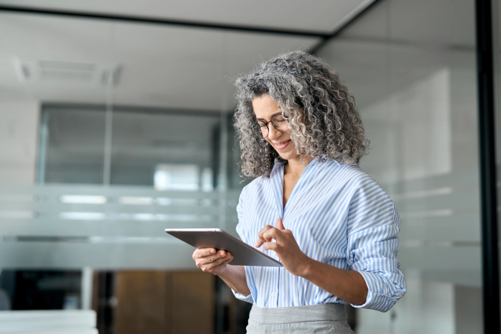 professional woman looking at a tablet at work