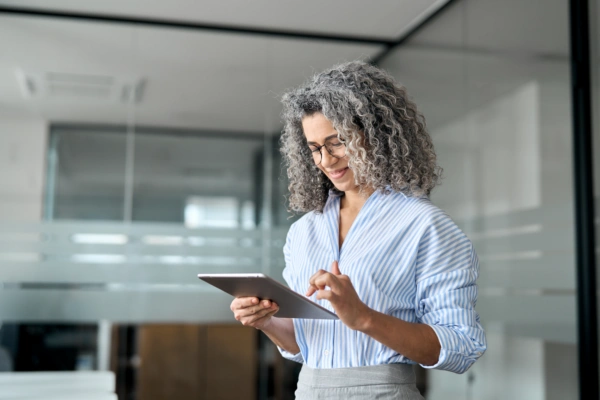 professional woman looking at a tablet at work