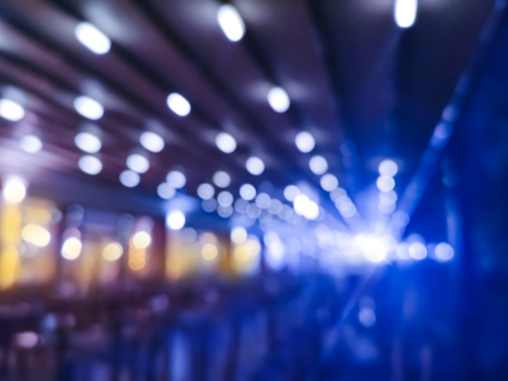 Blurred blue and purple lights creating bokeh circles in a dark setting.