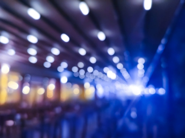 Blurred blue and purple lights creating bokeh circles in a dark setting.