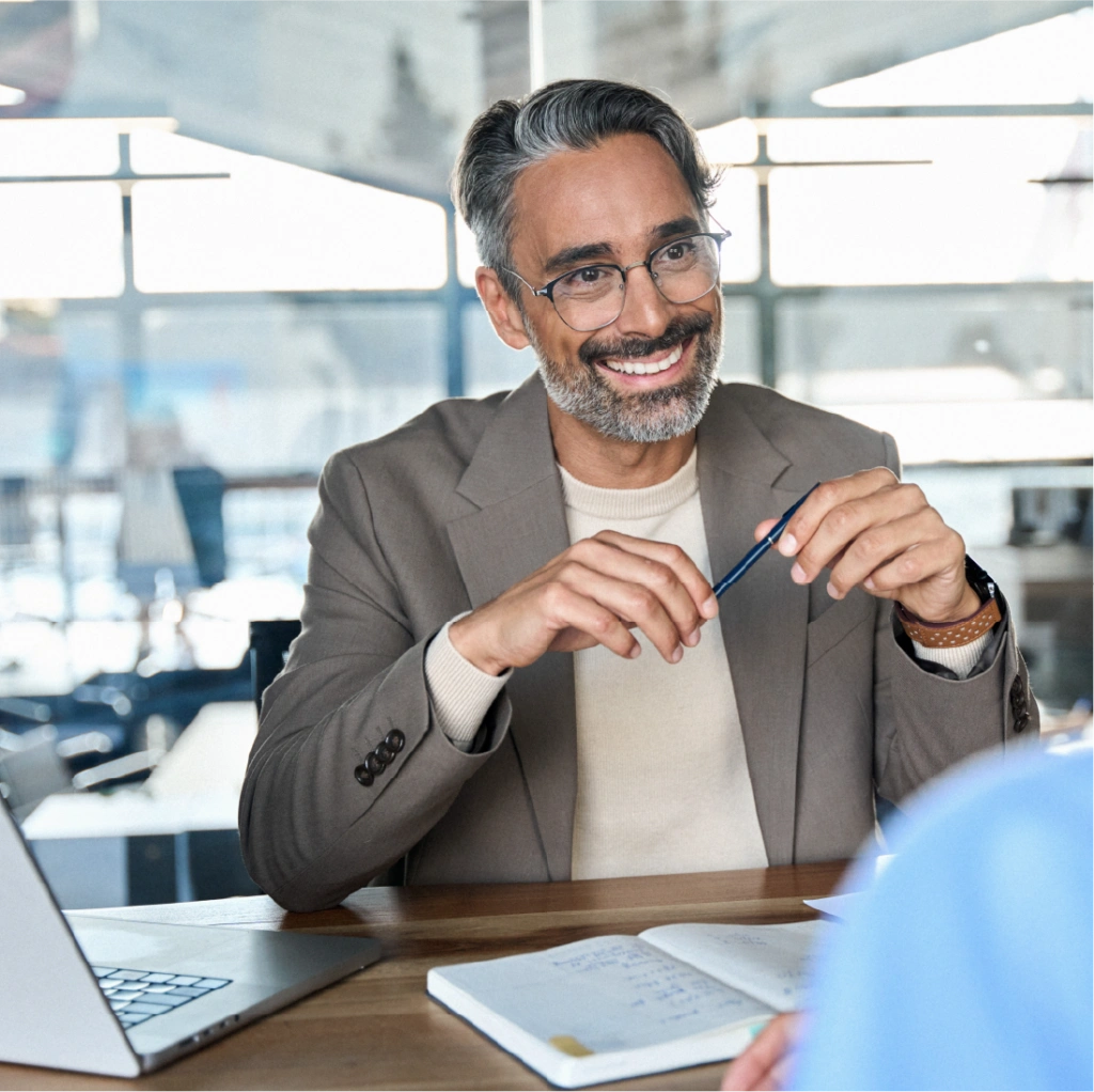 smiling man in a boardroom