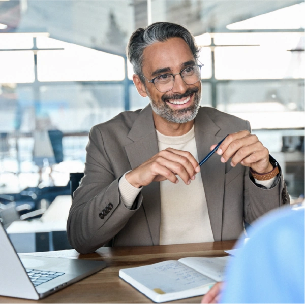 smiling man in a boardroom